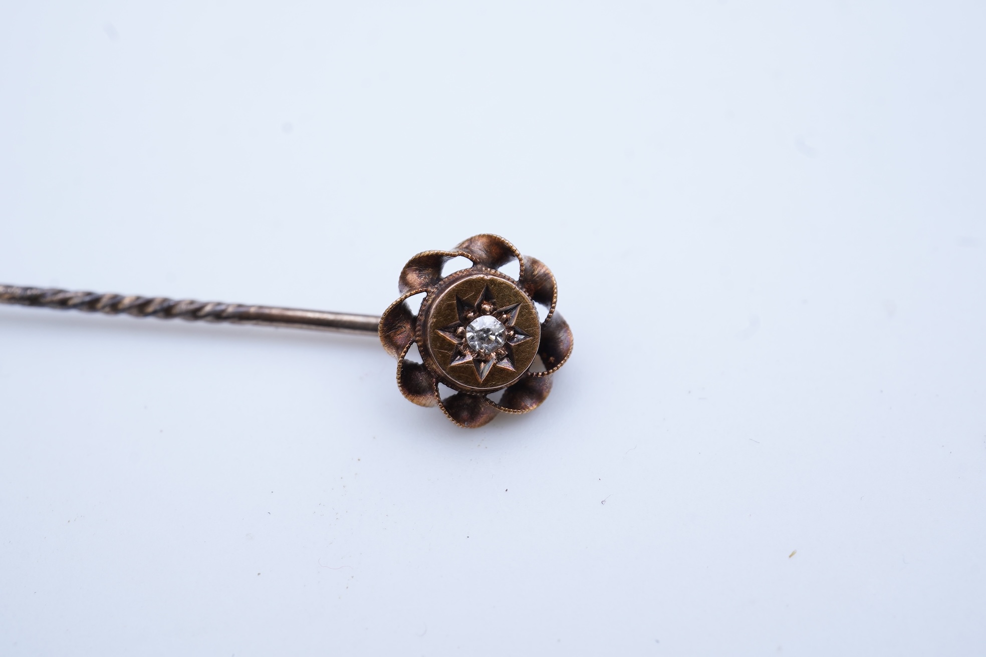 A group of three rings and a tie pin